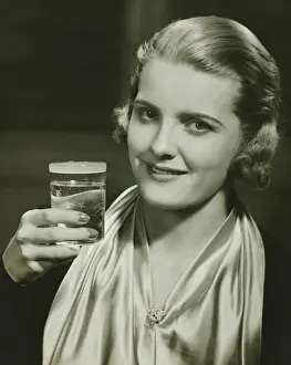 Silk Prints: Elegant woman raising glass of water, posing in studio, (B&W), close-up, portrait