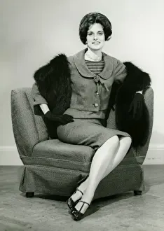 One Mid Adult Woman Only Prints: Elegant woman sitting on arm chair in studio, (B&W), portrait