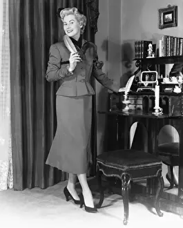 Quill Pen Prints: Elegant woman standing at desk in living room (B&W)