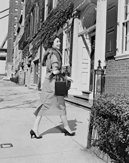 Purse Prints: Elegant woman walking outside apartment buildings