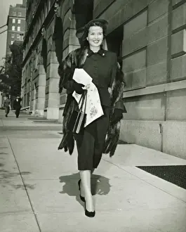 1950s Style Prints: Elegant woman walking on sidewalk, (B&W)
