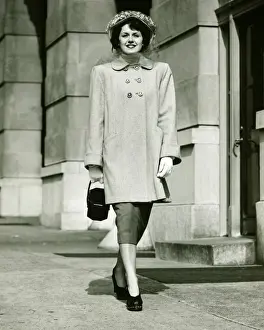 Glove Prints: Elegant woman walking on sidewalk, (B&W)