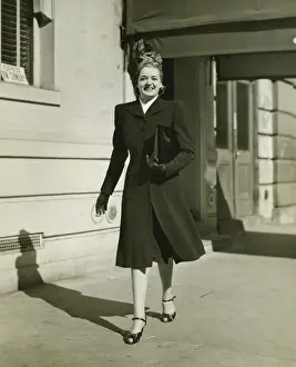 Headscarf Prints: Elegant woman walking on sidewalk, (B&W)