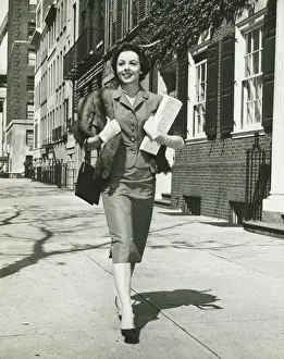Enjoyment Prints: Elegant woman walking on sidewalk, holding bags, (B&W)