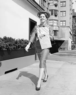 40 49 Years Prints: Elegant woman walking on street after shopping, (B&W)