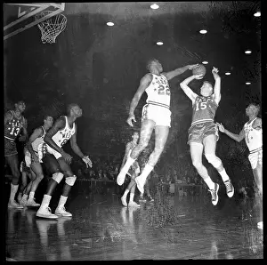 Elgin Baylor Trying to Block Heinson Shot