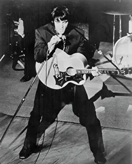 Elvis Presley Singing with Guitar and Tilted Microphone Stand