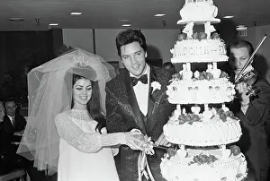Elvis and Priscilla Presley with Wedding Cake