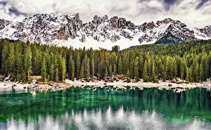 Tyrol Prints: The emerald green Lake Carezza reflects the trees in the western Dolomite mountains of northern Italy