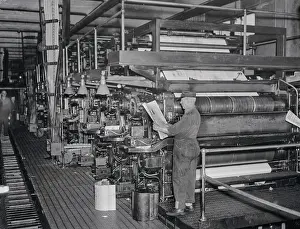 Employee Holding Newspaper in The Journal American Press Room