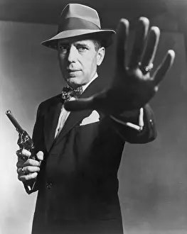 Prints of 1951: American actor Humphrey Bogart carrying a gun and holding out his hand, in a still from director Bretaigne Windust's film, The Enforcer'. (Photo by American Stock/Getty Images) The Essence of Cool: The Enforcer
