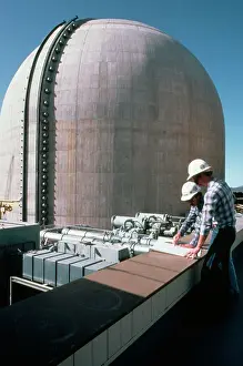 Blueprint Prints: Engineers Study Plans Near Reactor
