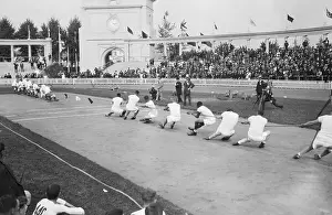 Prints of 1920: England team beats USA team in tug of war, during the 1920 Summer Olympics, Antwerp, Belgium. This was the last Olympics with tug of war as an event. Team members (not in order): (GBR) Capturing Glory: A Journey Through Olympic History: England Beats USA in Tug of War