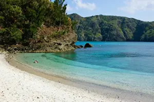 Enjoying clear tropical water of white sandy beach