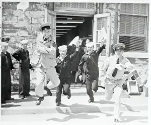 Exiting Prints: Enlisted Men Waving Their Discharge Papers in the Air