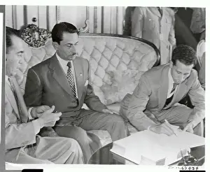Enrique Oliva Signing a Document