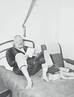 Ernest Hemingway Reading in Bed
