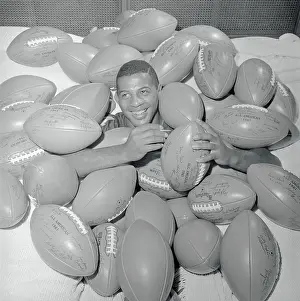Ernie Davis Buried Beneath Footballs