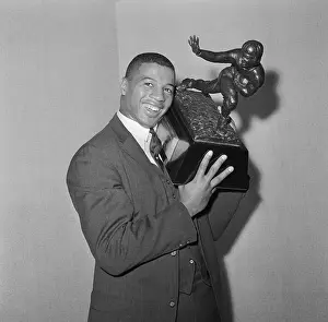 Ernie Davis Holding Trophy