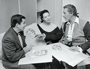 Errol Flynn, Mil Patrick, and Bud Westmore Discussing Sketches