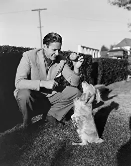 Playful Prints: Errol Flynn Playing with Pet Dog