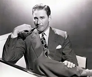 Errol Flynn Smoking a Pipe