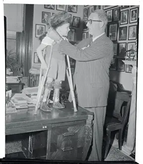 Estes Kefauver Placing a Coonskin Cap on Tommy Woodward