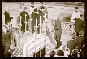Eugene McCarthy walking Near Flag Draped Coffin