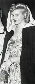 Eva Peron Pausing in Caped Fashion