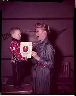 Eve Arden Gasping at Gift from Young Boy