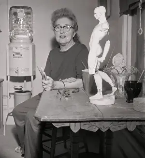 Evelyn Nesbit Sitting with Sculpture on Table