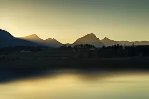 Evening light on the shore of Hopfensee Lake, Allgaeu Alps at back, Fuessen, Ostallgaeu region, Allgaeu, Bavaria