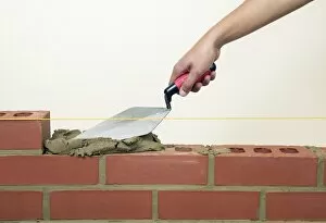 Evening off mortar on bricks with a trowel
