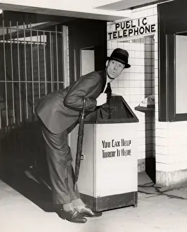Executive with arm in public trash receptacle