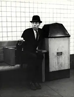 Executive with arm in public trash receptacle