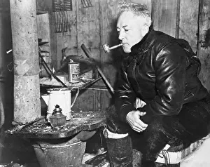 Antarctica Prints: Explorer Admiral Richard Byrd Smoking Pipe by Heater