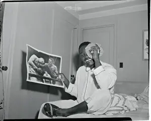 Ezzard Charles Holding a Photograph