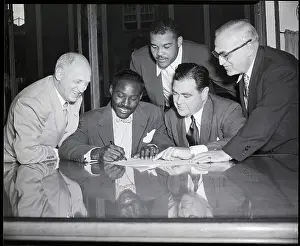 Contract Prints: Ezzard Charles Signs Boxing Contract