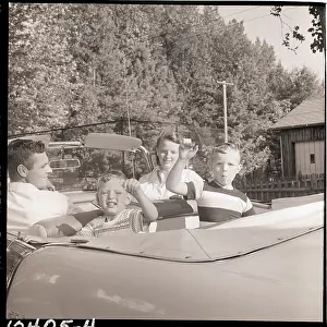 Looking Back Prints: Family Drives Away In Convertible