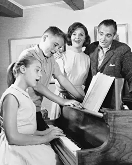 Pianist Prints: Family gathered around piano, singing
