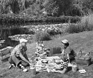 Two Parents Prints: Family having picnic by pond