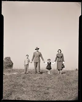 Family Holding Hands in Open Field