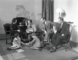 Two Parents Prints: Family in living room daughter and son play on the floor mother and father talk to another couple
