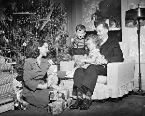 Father Prints: Family opening Christmas presents, children (2-3) (4-5), (B&W)