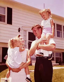 Family outside suburban home. (Photo by H. Armstrong Roberts / Retrofile / Getty Images)