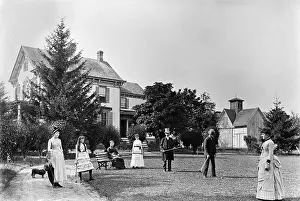 Family Plays Croquet in Front of Home