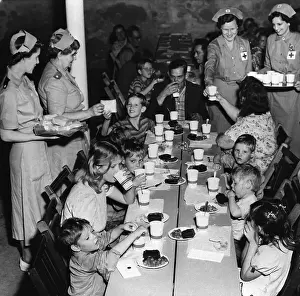 Flood Prints: Family Of Ten Seated & Being Fed/Red Cro
