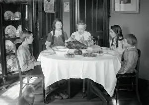 Family Sitting Around Dinner Table