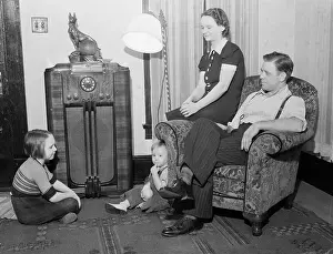 Family Sitting by Radio