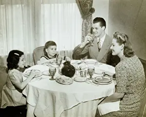 Father Prints: Family sitting around table, having meal, children (4-5) (6-7), (B&W)